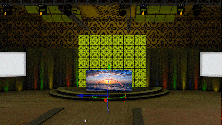 The Media tool is pushed backwards and up against a bright green wall behind a semi-circular stage. There is an image of a sunset displayed on the Media tool’s screen.