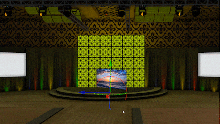 The Media tool is rotated then placed against a bright green wall behind a semi-circular stage. There is an image of a sunset displayed on the Media tool’s screen.